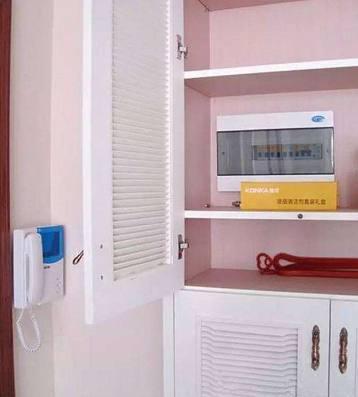 老電工把配電箱安裝在墻內。曬太陽太聰明了。